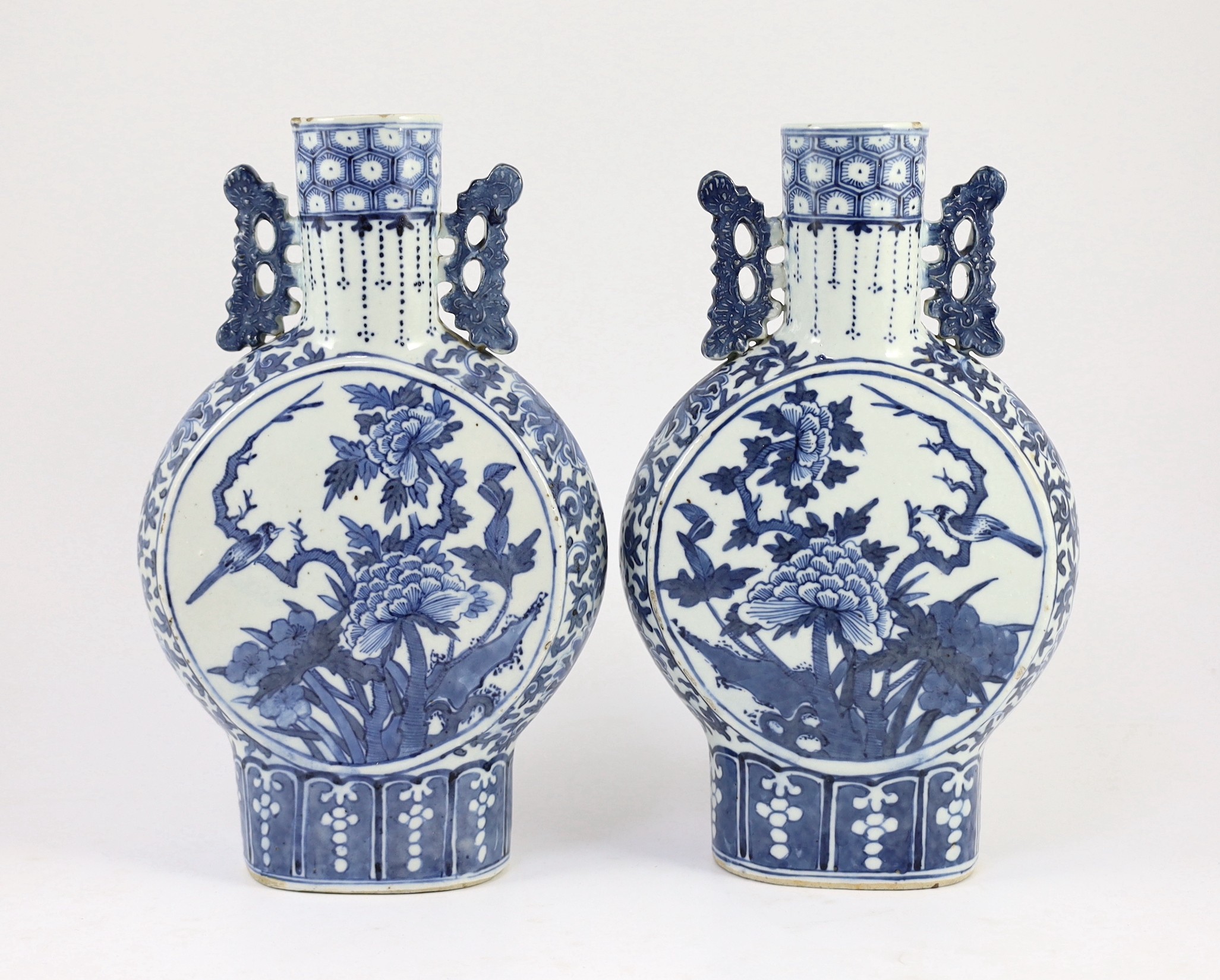 A pair of Chinese blue and white moon flasks, 19th century, 30cm high, small glaze losses and firing cracks